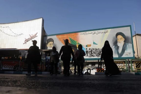 People walk next to a mural with a picture of Iran's Supreme Leader, Ali Khamenei, on a street in Tehran, Iran, November 5, 2025.