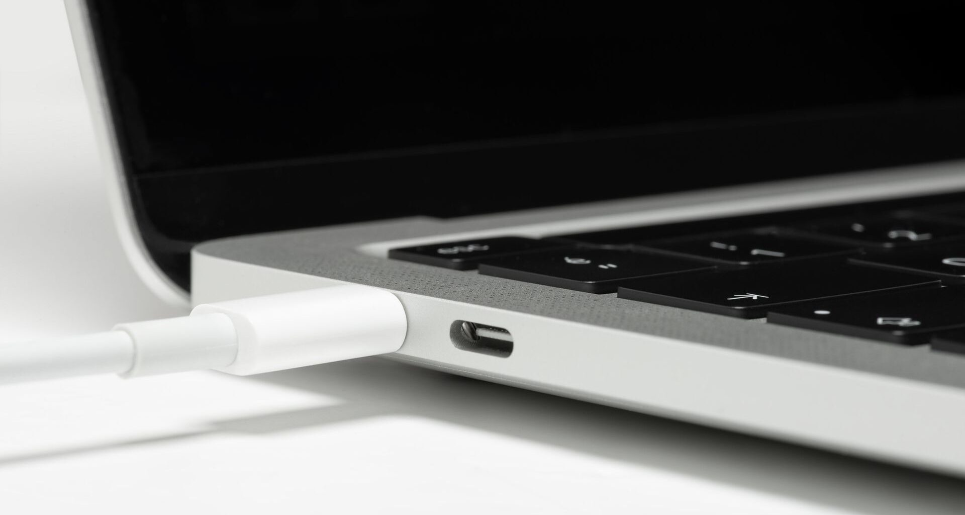 A photo of a MacBook laptop being charged.