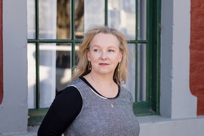 Heather stands outside a library building