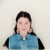 Sydney Bradley brown hair denim vest slightly smiles