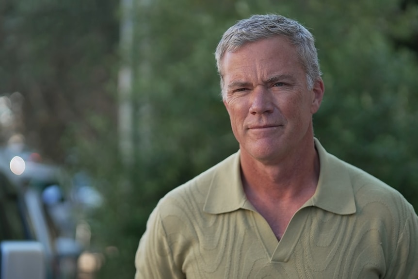 David Baxby is middle aged in a sweater looking at the camera