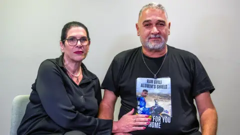 Itzik and Talik Gvili, the parents of dead Israeli hostage Ran Gvili, pose for a photo during a visit to London