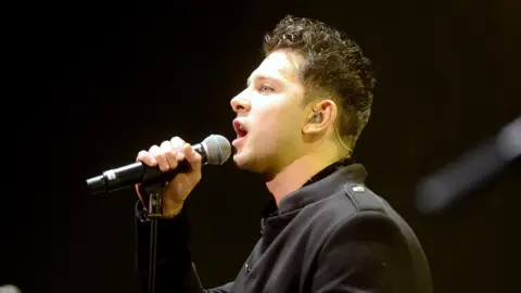 Getty Images Ross Davidson performing on stage in 2018 