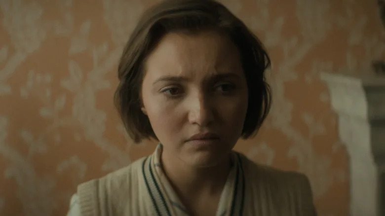 Mia McKenna-Bruce's Lady Bundle Brentin is seen in closeup looking worried in Agatha Christie's Seven Dials