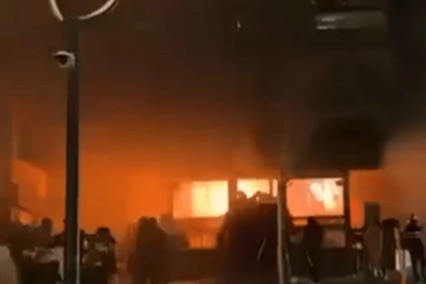 A building with flame coming out of it.