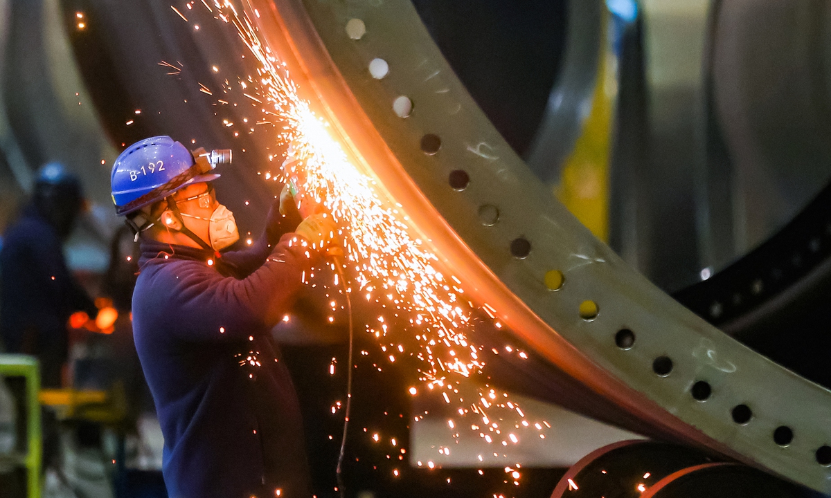 A worker operates in the production workshop of China Construction Equipment & Engineering Co in Nanjing of East China