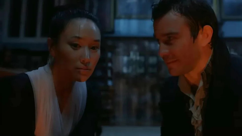 Luke Thompson looks at Yerin Ha in Bridgerton.