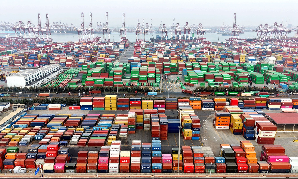 Containers are loaded at the hustle and bustle of Qingdao port in East China