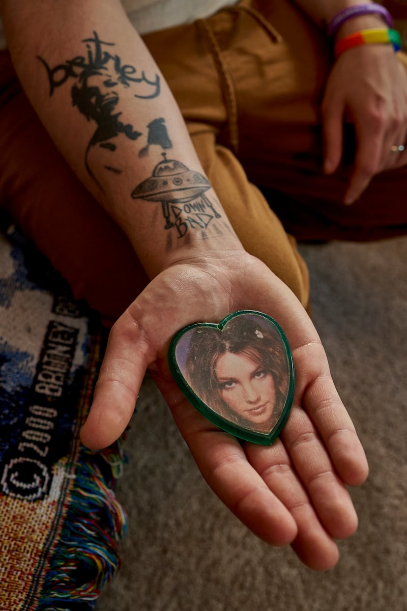 Zachary Gordon-Abraham with an image of Britney Spears from his collection of Spears memorabilia at his home in Pennsylvania. Photograph: Noah Kalina/The New York Times
                     