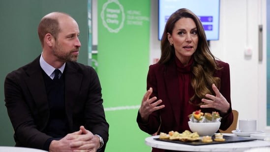 Britain's Prince William (L), Prince of Wales and Catherine, Princess of Wales react as they meet healthcare staff during a visit to Charing Cross Hospital in west London on January 8, 2026, to highlight the work of NHS staff and volunteers. (Photo by Isabel Infantes / POOL / AFP)(AFP)