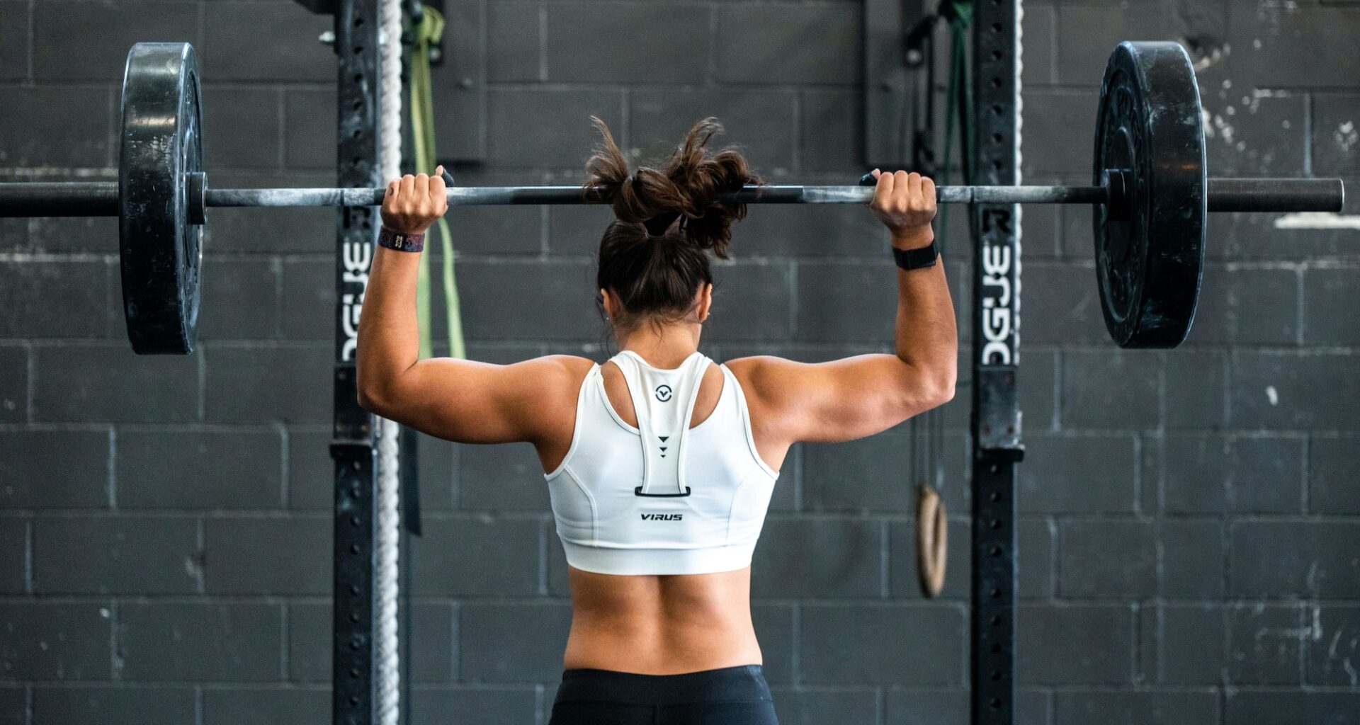 photo of a woman lifting weights at a gym