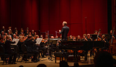 orchestra musicians and conductor on a stage