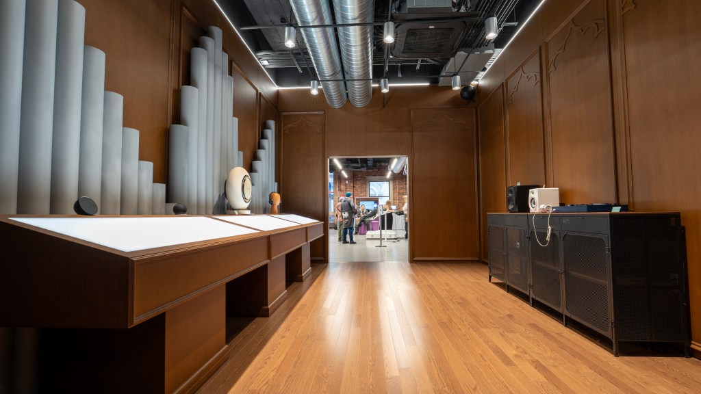 A wood-walled room with speakers lining the walls.
