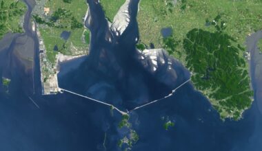 Visible from space, a 33 km structure, considered the world's largest sea wall, closed off an entire bay, created artificial land, and placed economic development and environmental preservation on opposite sides
