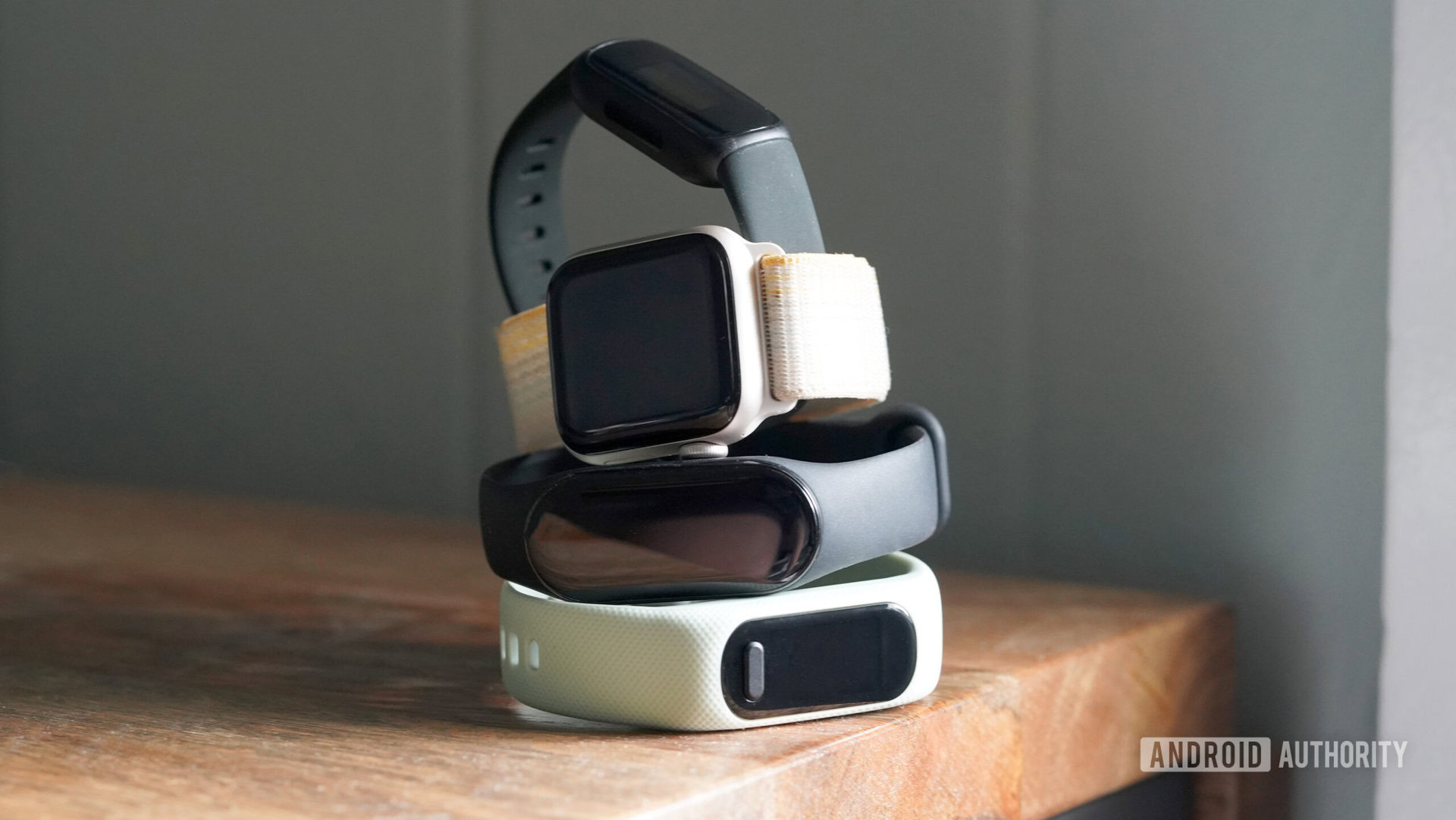 A stack of fitness trackers represent Xiaomi Mi Band 8 alternatives.