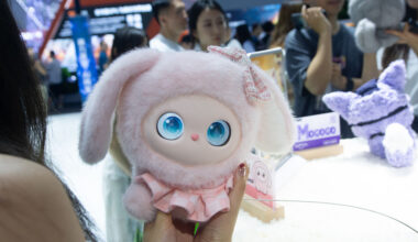 A general view shows fairgoers playing with an interactive doll at the Nubia booth at the Shanghai New Expo Center during the opening day of the World Artificial Intelligence Conference (WAIC) 2025 in Shanghai, China