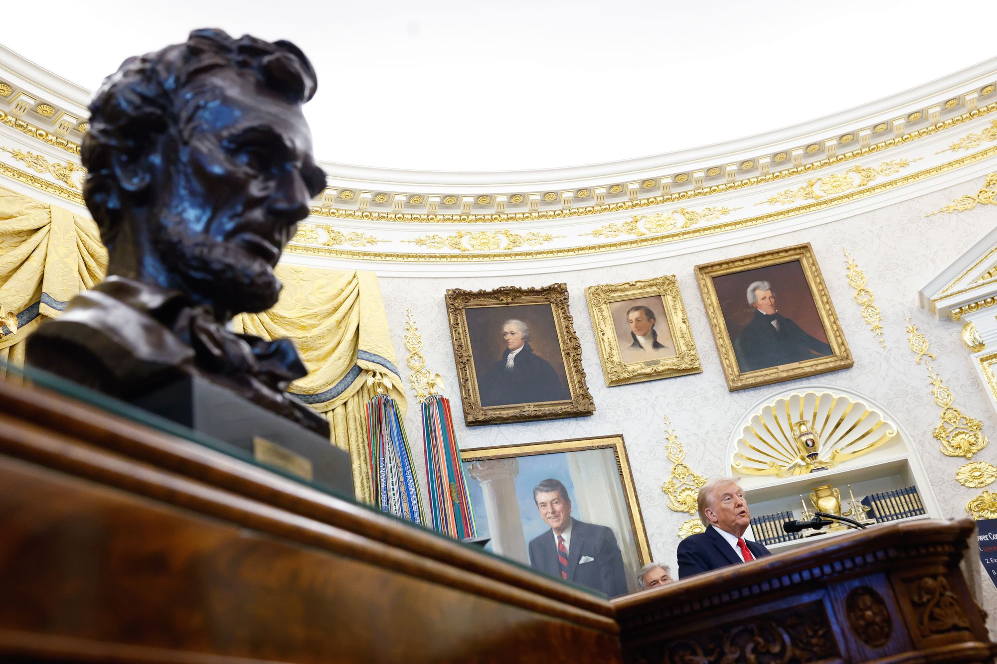 President Donald Trump answers questions from reporters during an event in the Oval Office of the White House on October 16, 2025