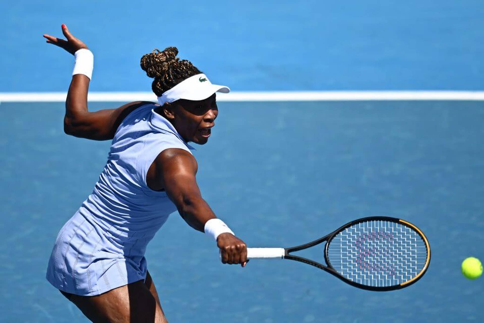 Venus Williams hits a backhand shot.