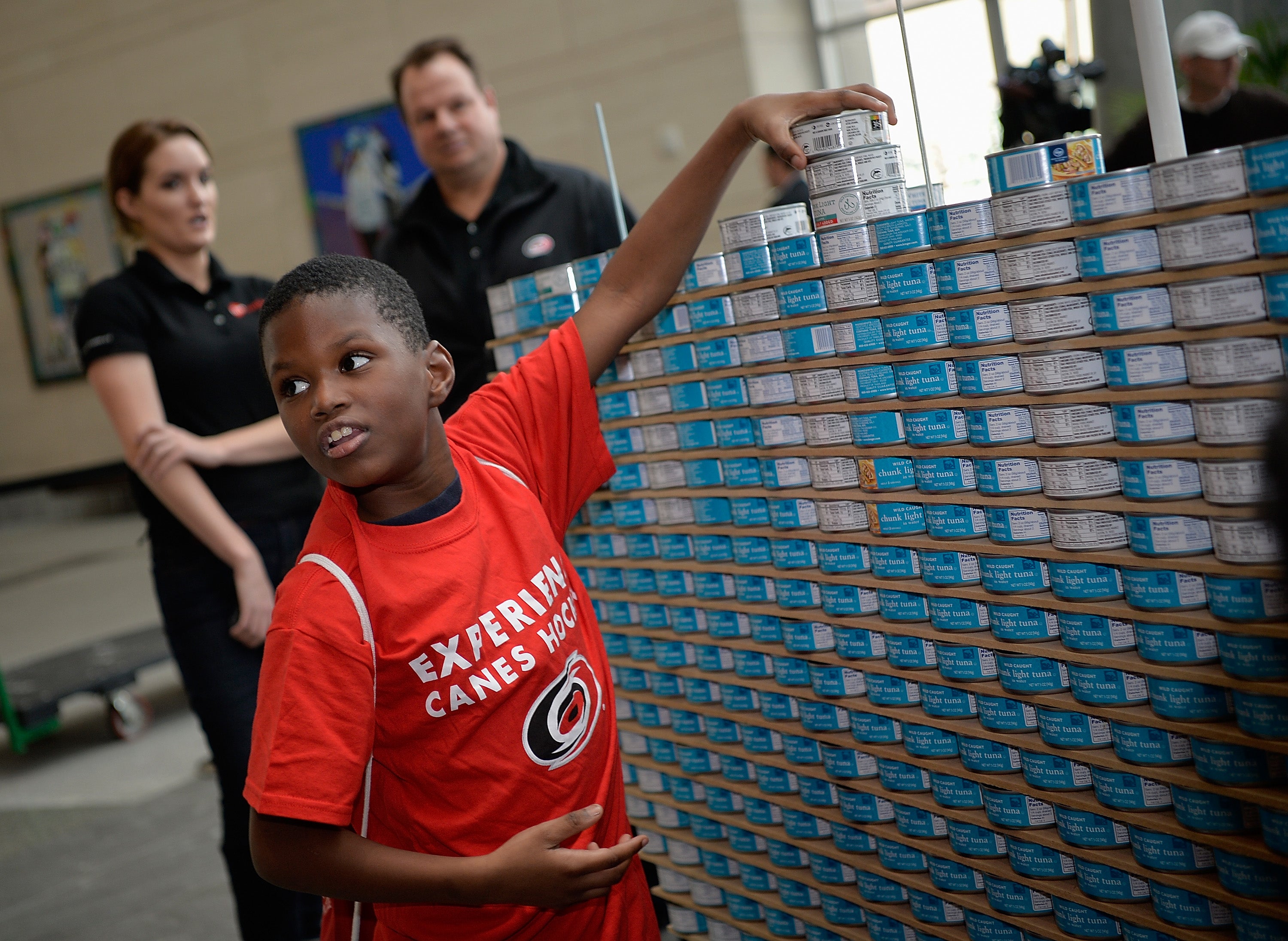 Kids make a tower of canned tun fish in Raleigh, North Carolina, in January 2016. Canned goods can offer a cheaper way to boost your daily protein intake