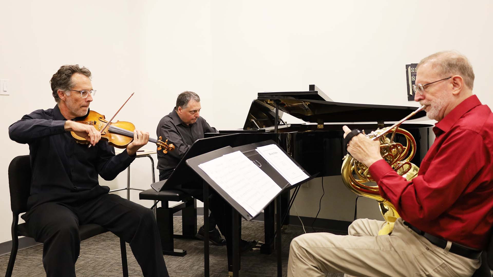Horn member musicians rehearse for the upcoming performance