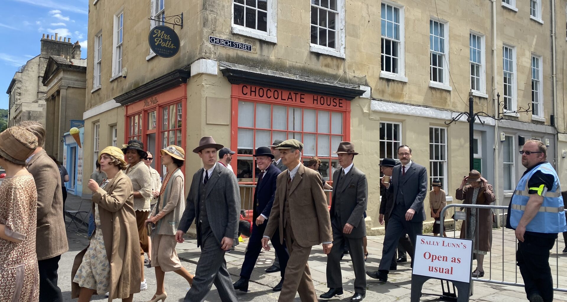 Behind the scenes photo of Netflix's Agatha Christie’s Seven Dials, featuring people in period dress.