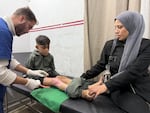 Mohammed Ibrahim, 14, receives treatment after being run over by a truck trying to get food during a famine this summer at MSF’s clinic in Gaza City on Dec. 31, 2025.