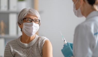 Doctor giving a senior woman a vaccination.