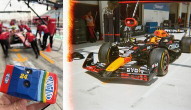 A person holds a colorful disposable camera in the foreground, while in the background there are blurred Formula 1 pit crew members; on the right, a Red Bull F1 car is parked in the pit lane.