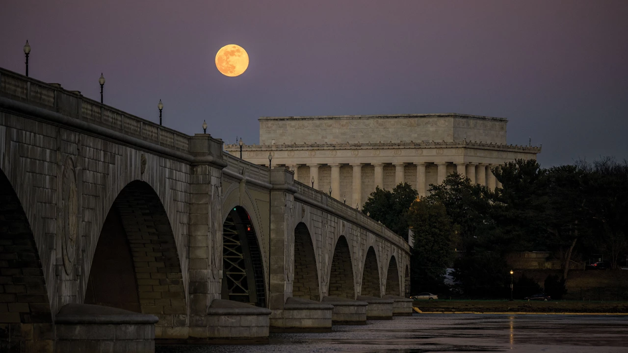 A full moon is seen over the Lincoln Memorial and Arlington Memorial Bridge in Washington, DC.