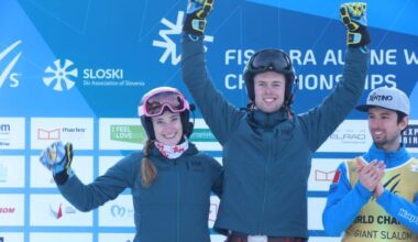 A female and male skiers are celebrating on the podium