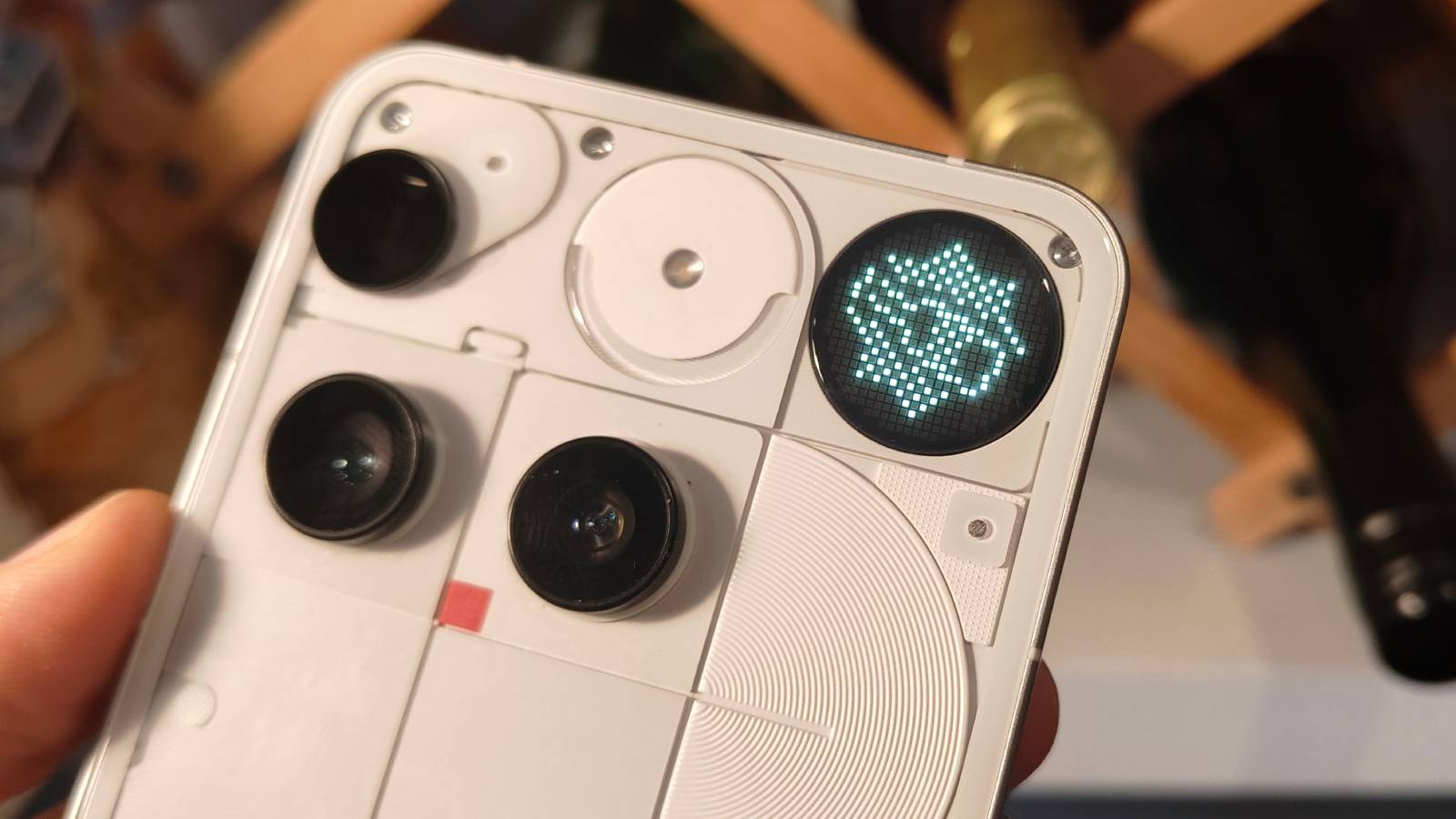 The Nothing Phone (3)'s rear, showing its cameras and the Glyph Matrix on spin-the-wheel mode.