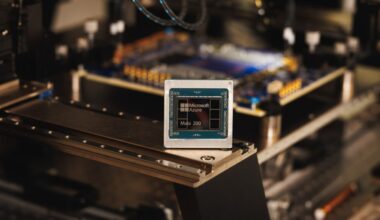 The Maia 200 AI accelerator chip with cables and equipment in the background.