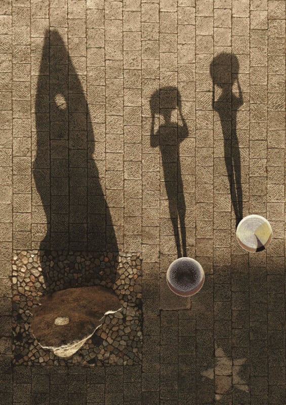 Two people carrying baskets on their heads cast long shadows on a stone pavement; a circular stone and a traditional conical hat are visible on the ground.