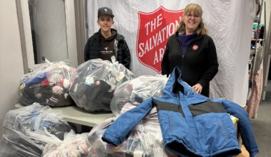 Owen and Abbigail stand in front of donated items