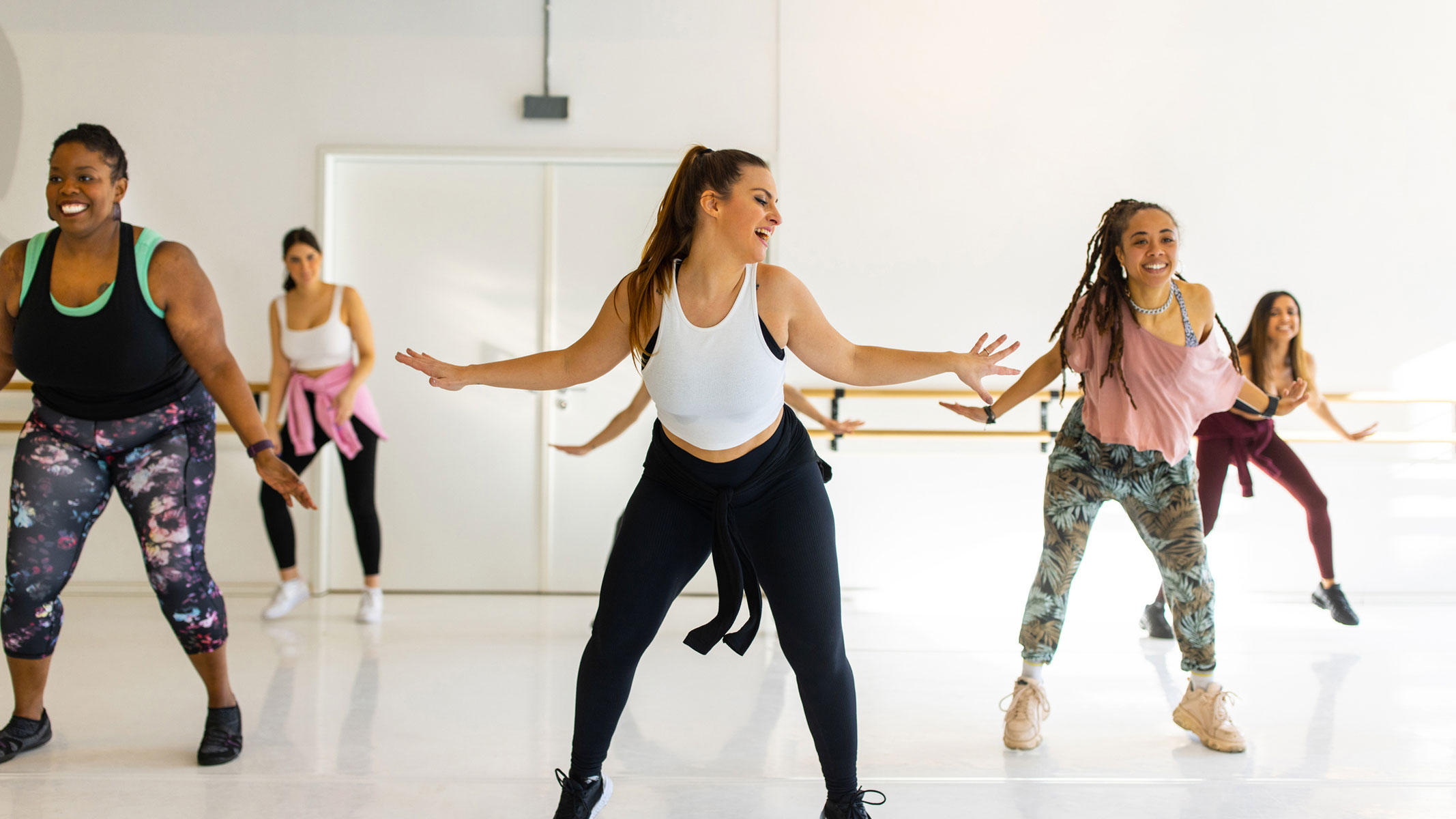 A picture of a group of young women participating in a dance class