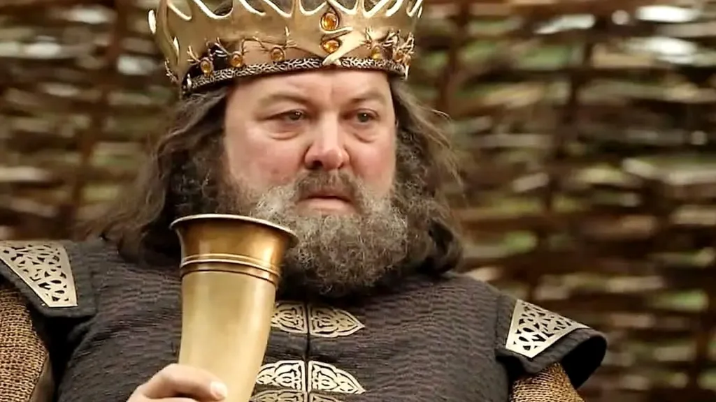 Robert Baratheon looking annoyed with a drinking horn in his hand in Game of Thrones Season 1