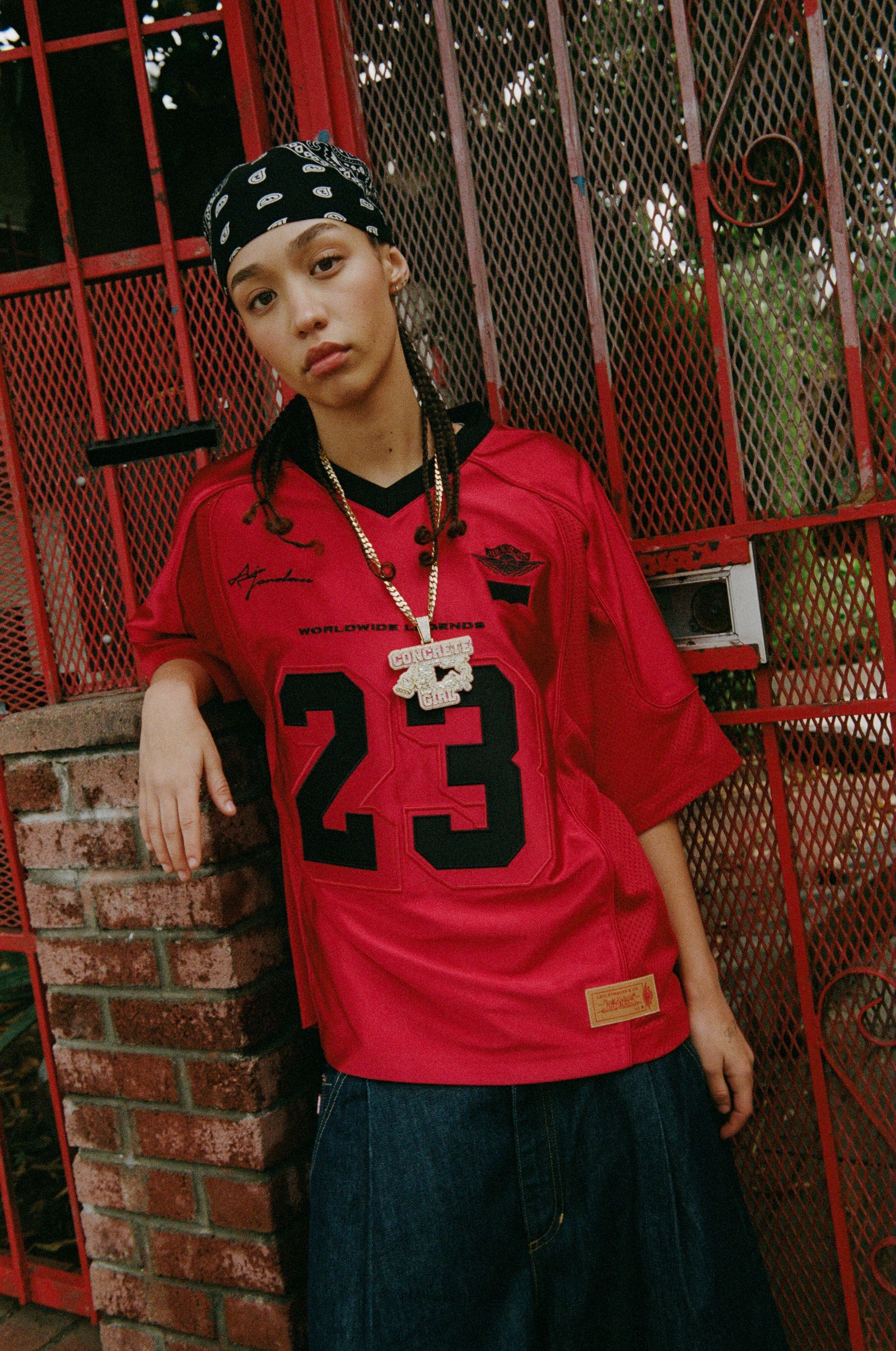 Image may contain Clothing TShirt Photography Sleeve Person Teen Face Head Portrait Pants Jeans Braid and Hair