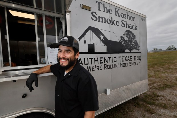 Owner Ari Gomez with his The Kosher Smoke Shack food truck. (Amy Beth Bennett/South Florida Sun Sentinel)