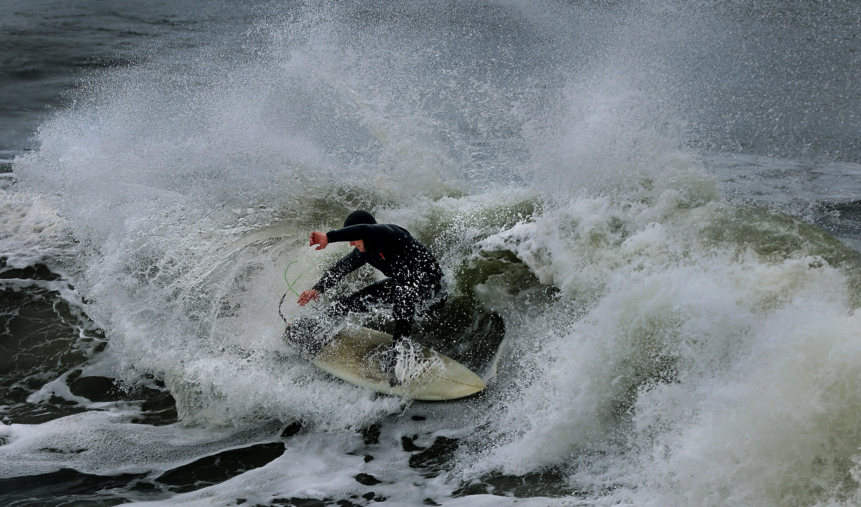 A surfer takes advantage of high tide at Salmon Creek...