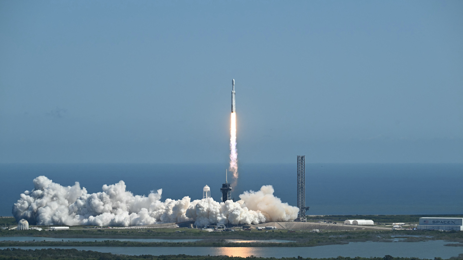 A photo of a Falcon Heavy rocket lifting off a launch pad