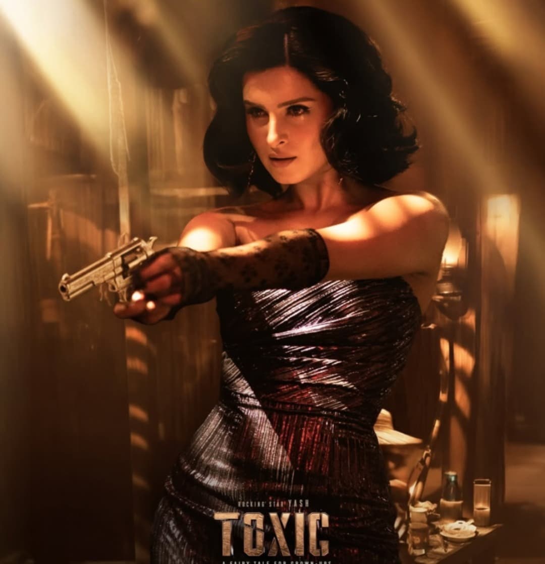 One of the latest characters introduced in the film is Tara Sutaria as Rebecca. In her first-look poster, the actress flaunted a retro-inspired, fierce avatar. She is seen wearing a strapless gown and delicate lace gloves, aiming a gun at someone with a piercing gaze.