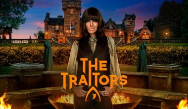 Host Claudia Winkleman poses in front of a Scottish castle and stone fire pits, with two mysterious green-cloaked figures in the background.