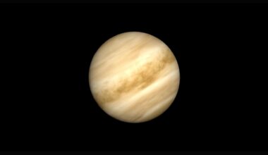 A close up of the planet Venus in the darkness of space, its yellow surface prominent