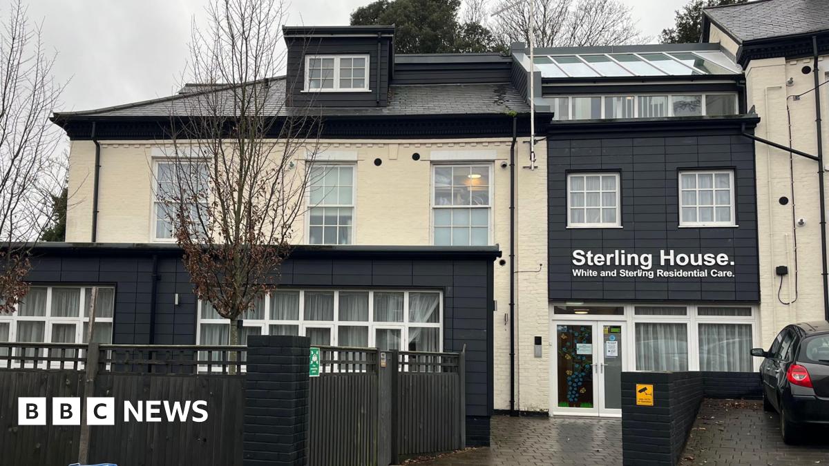 The outside of Sterling House in Norwich. The building is painted cream with some sections including the room painted black. There is a sign on the building which says Sterling House, on it.
