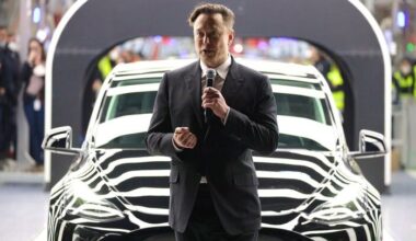 Elon Musk in front of a Tesla
