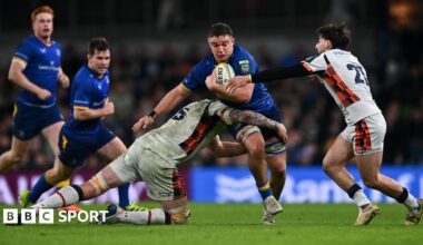Scott Penny is tackled by Glen Young, left, and Charlie Shiel of Edinburgh during the United Rugby Championship match between Leinster and Edinburgh