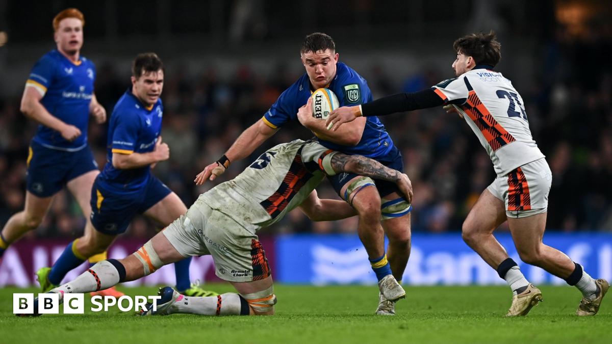 Scott Penny is tackled by Glen Young, left, and Charlie Shiel of Edinburgh during the United Rugby Championship match between Leinster and Edinburgh