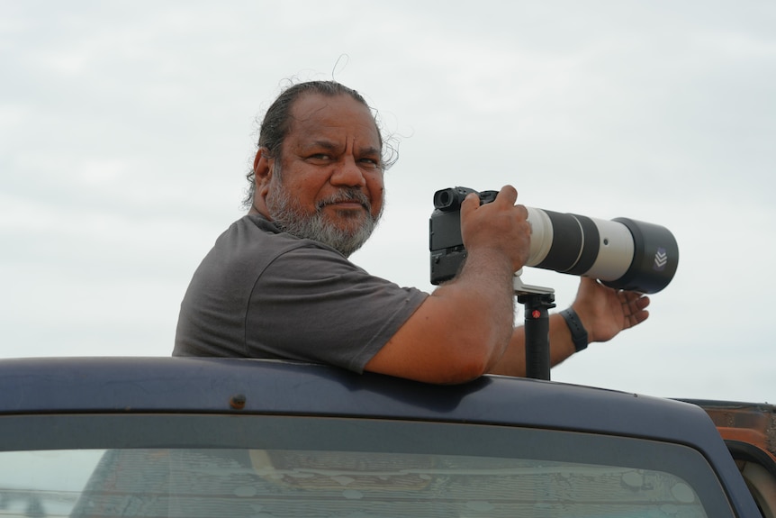 a photographer taking pictures of surfers.