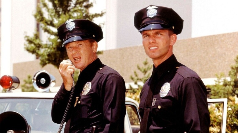 Officers Pete Malloy and Jim Reed use the police radio in Adam-12