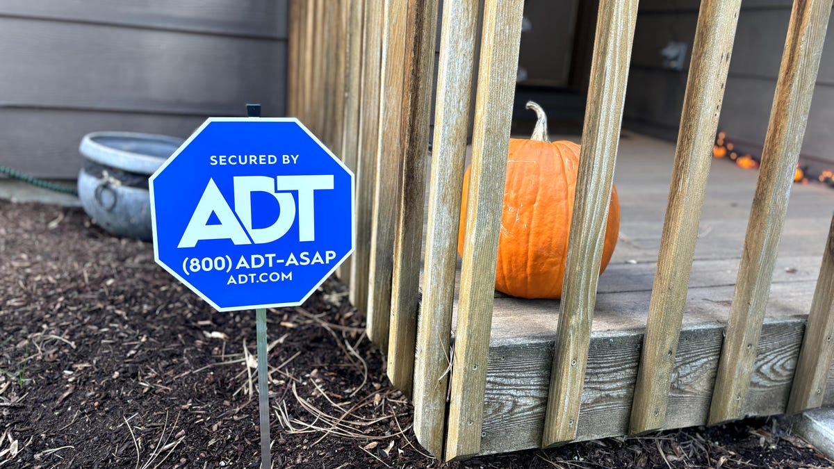 ADT sign in front yard in fall.